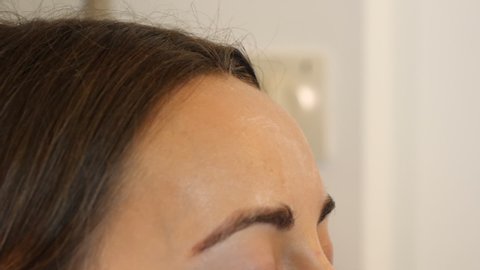 Glossy makeup foundation base being smeared on forehead, close up shot, videoclip de stoc