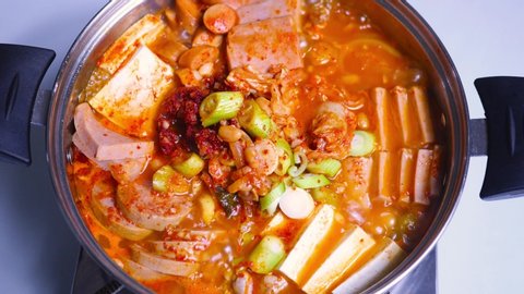 Korean food : Budaejjigae. A fusion dish made with ham, sausage, kimchi, pork, and bean curd.Everything is combined and cooked in a spicy broth. Ramen noodles are often added to the simmering stew. Stock-video
