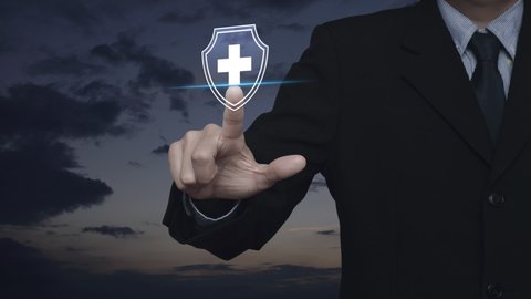 Businessman pressing cross shape with shield flat icon over sunset sky, Business healthy and medical care insurance concept Stock-video