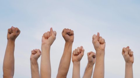 Teamwork. A group of people against the sky raises their hands up. The concept of voluntary voting, expression of consent, support for democracy. – Video có sẵn