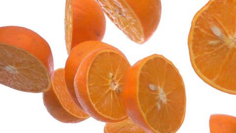 Close-up of sweet halves of orange falling diagonally on the white background 库存视频