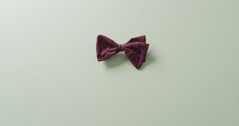 Video of red and black bow tie lying on grey background. men fashion, clothes, accessories and elegance concept. Arkistovideo