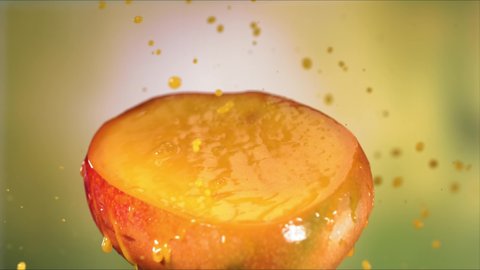 Half fresh yellow mango fruit juice drop, splashing juice on half mango Video stock