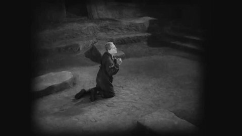 Circa 1927 - in this silent german expressionist film, a man falls to his knees at a woman's altar, believing her to be a mediator.: redactionele stockvideo