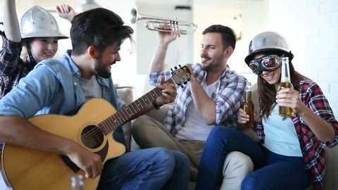 Cheerful friends having party together and playing instruments Stockvideó