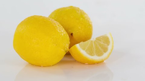 Pieces of lemon are falling down on a table. They look very fresh. Video de stock