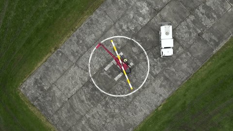 Helicopter Helipad Refueling fuel truck H top down birds eye view rotating flying upwards drone aerial Stock-video