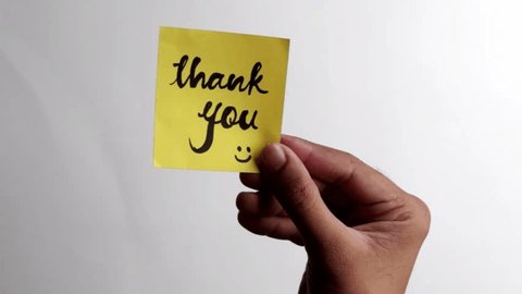 Sticky note Thank you being sticked to white surface स्टॉक व्हिडिओ