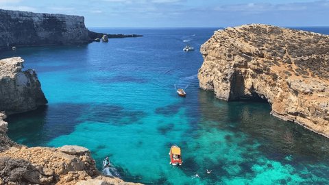 Luxury vacation. Visiting Comino caves in a boat, sea scooters and kayak. Malta, Mediterranean sea. High quality 4k footage Video de stock