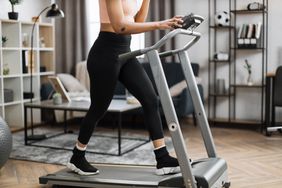 woman walking on treadmill at home