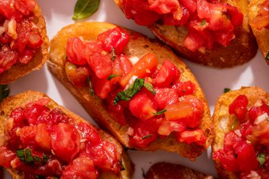 Close-up, overhead photo of bruschetta with tomato and basil