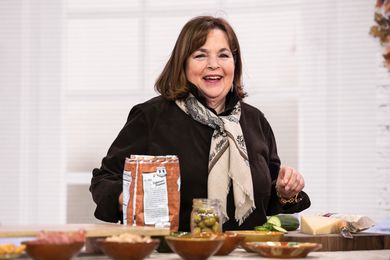 Ina Garten standing behind a counter with lots of snacks in bowls