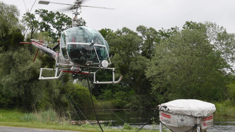 Ein Hubschrauber der Kommunalen Arbeitsgemeinschaft zur Bekämpfung der Schnakenplage KABS startet am Rheinufer.