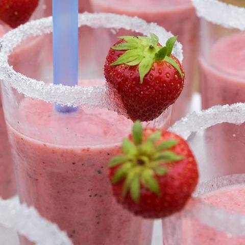 Erdbeer-Frappé im Glas mit Zuckerrand und zwei Erdbeeren