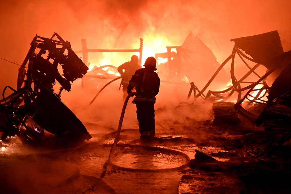 Ukrainian firefighters work to extinguish a fire in Kharkiv.