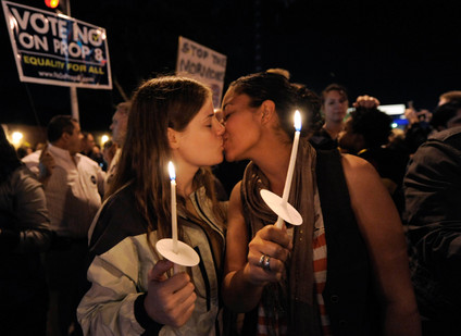 Joni Boettcher (left) kisses Tika Shenghur during a protest march.