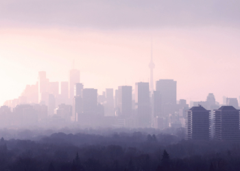 A haze over the city of Toronto, showing buildings and the CN Tower.