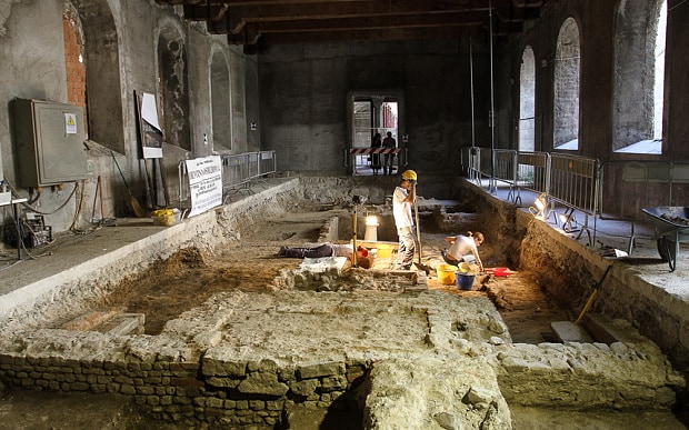 Archaeologists work on the excavation of a grave inside the medieval Convent of Saint Ursula in Florence 