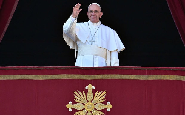 Pope Francis waves from the balcony of St Peter's basilica during the traditional 