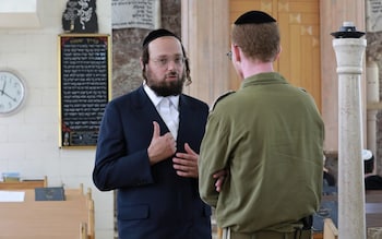 Rabbi Yonatan Reiss talks to Jacov Barchaim, an Israeli officer in the reservists forces who also works as a spiritual leader at the Yeshiva Chedvata