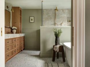 Large bathroom with calming sage green walls.