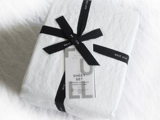 West Elm European Flax Linen Sheet Set folded and wrapped in a ribbon with tags