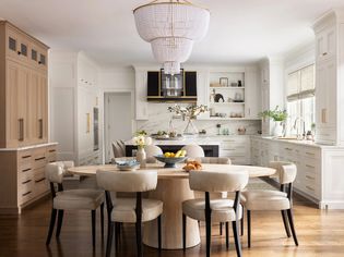 Modern eat in kitchen with an oval wooden table and upholstered chairs