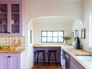 purple kitchen with green abstract backsplash
