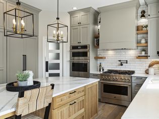 Kitchen with gray-green cabinets and lights
