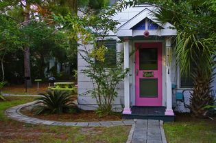 Pink front door of beach cottage