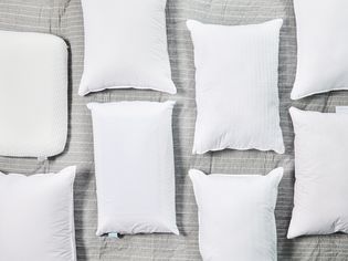 Several memory foam pillows displayed on a gray comforter