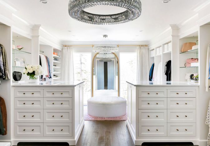multiple chandeliers and recessed lights in closet