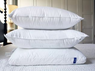 Stacked pillows we recommend displayed on a mattress