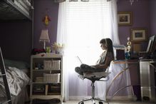 Young girl studying through technology at home