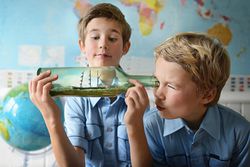 Boys Playing With a Ship in a Bottle