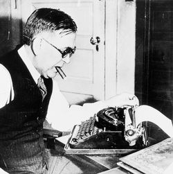 H. L. Mencken working with a cigar in his mouth