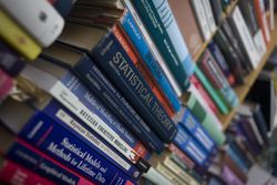 Academic books on a shelf