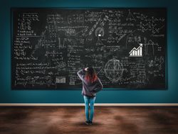 Confused girl in front of a blackboard full of formulas.