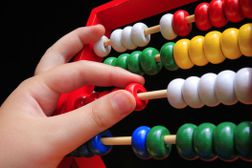a hand working a colorfiul abacus