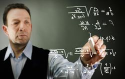 Businessman writing formulas