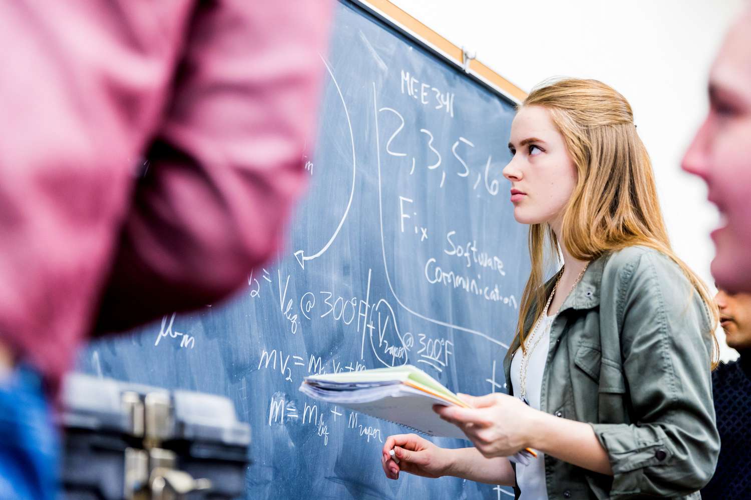 Students looking at a blackboard in math class.