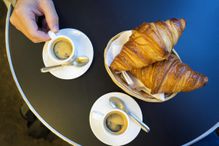 Espresso and croissants on round table