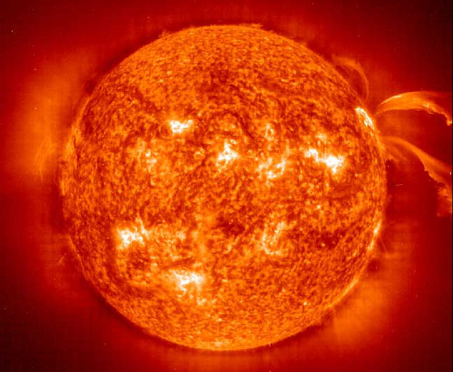 This image from the Solar and Heliospheric Observatory (SOHO) Extreme ultraviolet Imaging Telescope (EIT) image shows large magnetically active regions and a pair of curving erupting prominences on June 28, 2000 during the current solar cycle 23 maximum. Prominences are huge clouds of relatively cool dense plasma suspended in the Sun's hot, thin corona. Magnetically active regions cause the principal total solar irradiance variations during each solar cycle. The hottest areas appear almost white, while the darker red areas indicate cooler temperatures. Credit: NASA & European Space Agency (ESA)