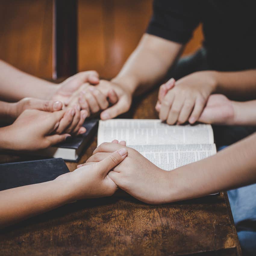 Prayer group holding hands
