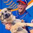Mets player Jeff McNeil holding his puppy