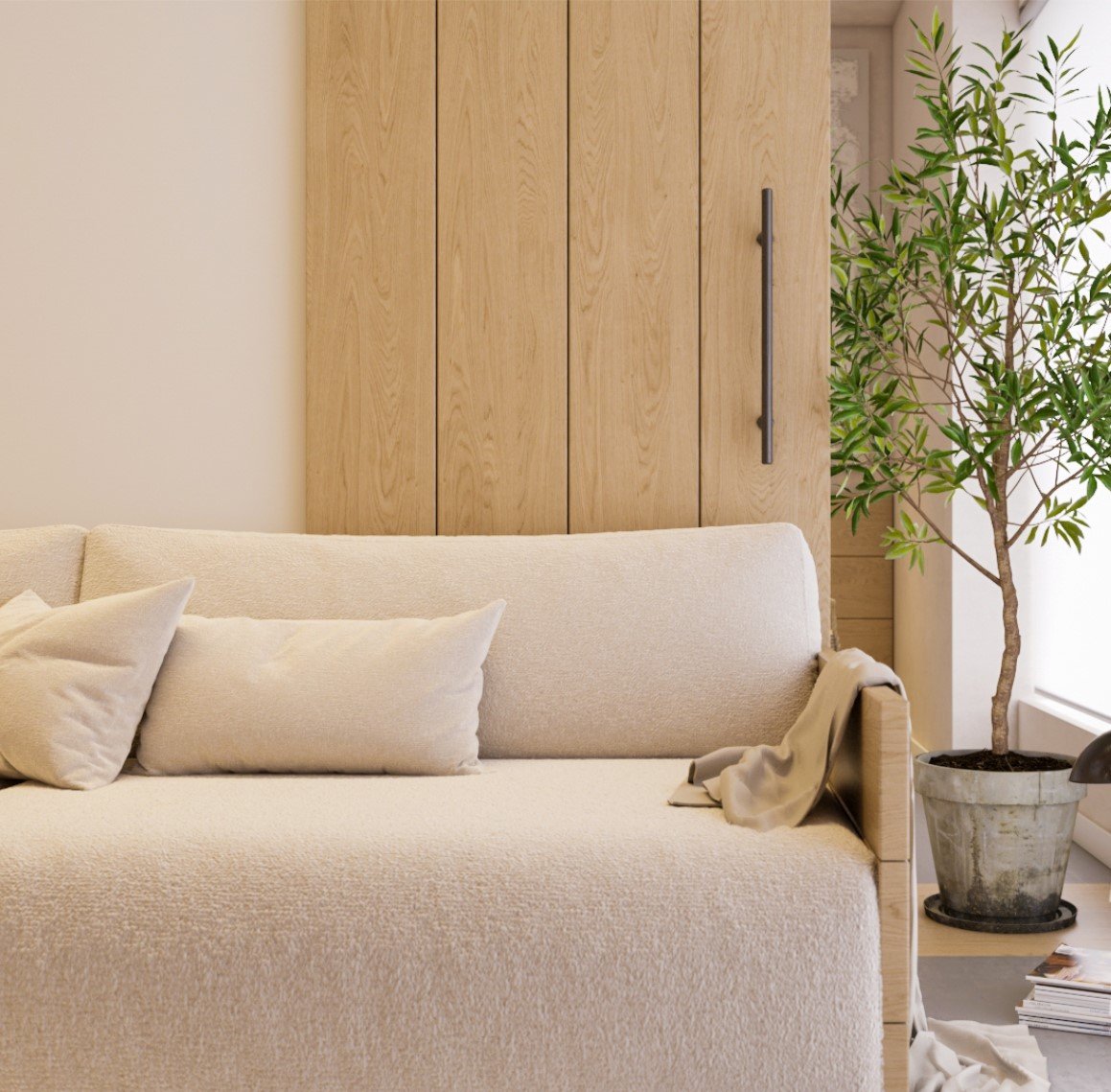 Home renovation details showcasing a plush beige sofa with soft cushions, wooden wardrobe doors, and a potted indoor tree enhancing the living space