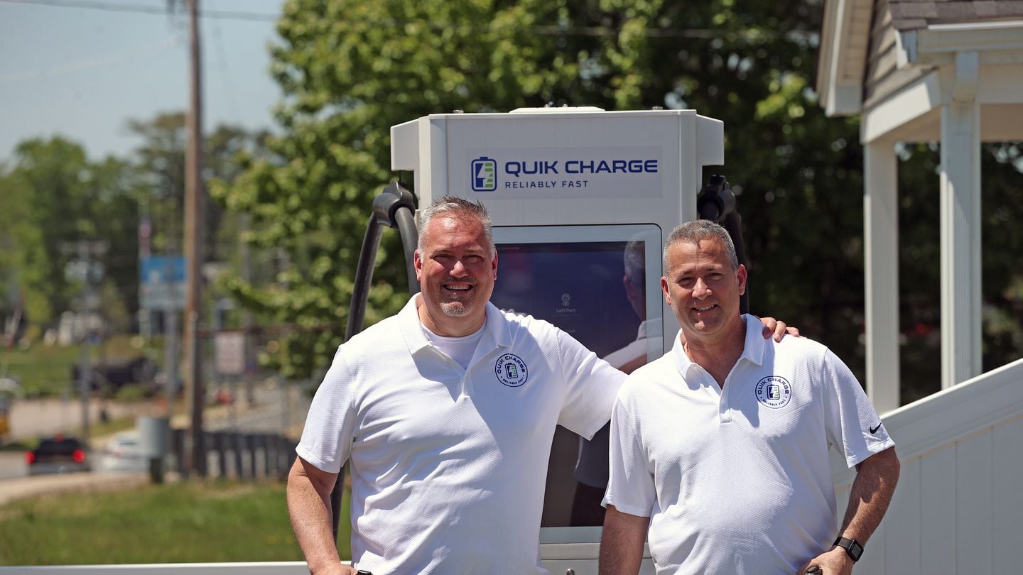 Owners Shawn Ward and Matt Kelcourse at their new EV fast-charging station in Weymouth, which uses a bank of lithium-ion batteries to charge vehicles at high speed without needing a high-voltage connection to the electrical grid.