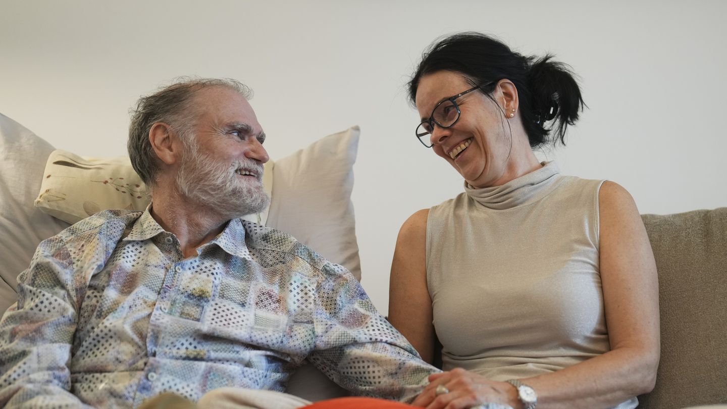 Michael Bommer, left, who is terminally ill with colon cancer, looks at his wife Anett Bommer at his home in Berlin, Germany, on May 22.