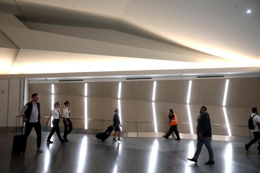 LOS ANGELES, CA - MAY 9, 2024 - Travelers make their way along the post-security hallway between Terminals 1 and 2 at LAX in Los Angeles on May 9, 2024. (Genaro Molina/Los Angeles Times)