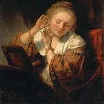 Рембрандт Харменс ван Рейн - Молодая женщина, примеряющая серьги